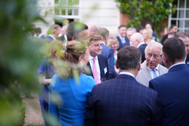 Britain's King Charles III (R) speaks to guests during a reception for recipients of the King's Award for Enterprise 2026 at St James's Palace in London on July 8, 2026. (Photo by Aaron Chown / POOL / AFP)