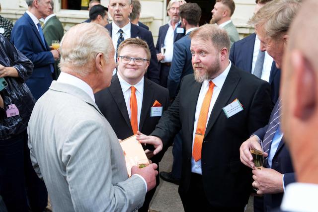 Britain's King Charles III (L) speaks to Ross Laing (behind C) and Christian Laing (R) of Stand Out Enterprises during a reception for recipients of the King's Award for Enterprise 2026 at St James's Palace in London on July 8, 2026. (Photo by Aaron Chown / POOL / AFP)