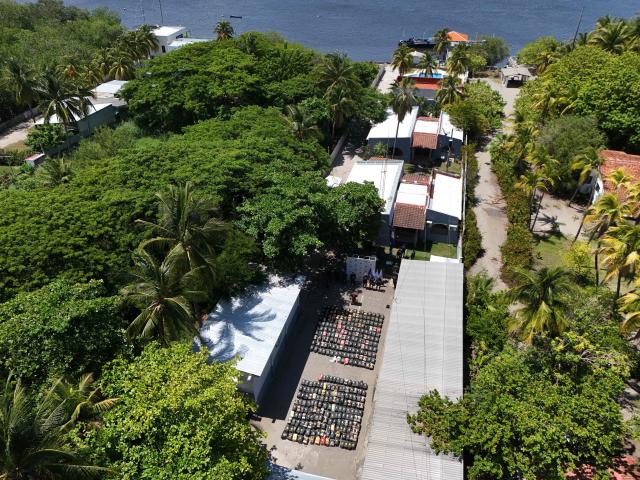 This aerial view shows packages of cocaine (bottom) seized during what authorities described as the largest drug seizure in El Salvador's history displayed during a press presentation at the Naval Base in San Luis La Herradura, El Salvador, on July 8, 2026. Salvadoran authorities said the 6.68-ton shipment, valued at approximately 167 million US dollars, was intercepted in two operations in international waters of the Pacific Ocean on June 18, leading to the arrest of six suspected drug traffickers of Colombian and Ecuadorian nationalities. (Photo by Marvin RECINOS / AFP)