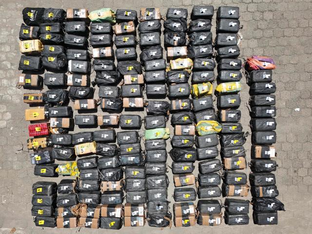 This aerial view shows packages of cocaine seized during what authorities described as the largest drug seizure in El Salvador's history displayed during a press presentation at the Naval Base in San Luis La Herradura, El Salvador, on July 8, 2026. Salvadoran authorities said the 6.68-ton shipment, valued at approximately 167 million US dollars, was intercepted in two operations in international waters of the Pacific Ocean on June 18, leading to the arrest of six suspected drug traffickers of Colombian and Ecuadorian nationalities. (Photo by Marvin RECINOS / AFP)