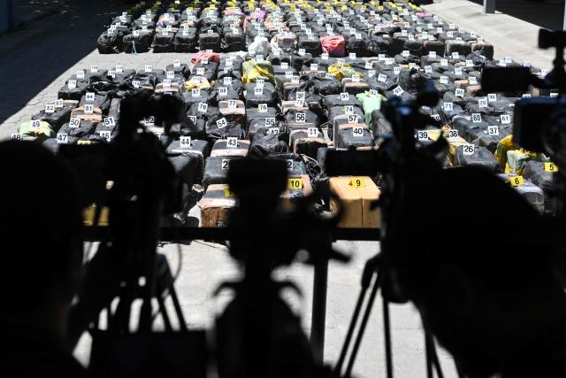 Packages of cocaine seized during what authorities described as the largest drug seizure in El Salvador's history are displayed during a press presentation at the Naval Base in San Luis La Herradura, El Salvador on July 8, 2026. Salvadoran authorities said the 6.68-ton shipment, valued at approximately 167 million US dollars, was intercepted in two operations in international waters of the Pacific Ocean on June 18, leading to the arrest of six suspected drug traffickers of Colombian and Ecuadorian nationalities. (Photo by Marvin RECINOS / AFP)