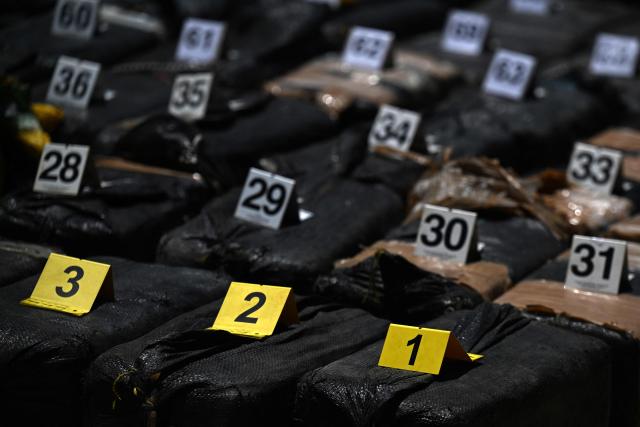 Packages of cocaine seized during what authorities described as the largest drug seizure in El Salvador's history are displayed during a press presentation at the Naval Base in San Luis La Herradura, El Salvador on July 8, 2026. Salvadoran authorities said the 6.68-ton shipment, valued at approximately 167 million US dollars, was intercepted in two operations in international waters of the Pacific Ocean on June 18, leading to the arrest of six suspected drug traffickers of Colombian and Ecuadorian nationalities. (Photo by Marvin RECINOS / AFP)