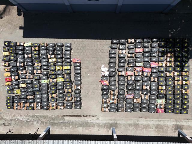 This aerial view shows packages of cocaine seized during what authorities described as the largest drug seizure in El Salvador's history displayed during a press presentation at the Naval Base in San Luis La Herradura, El Salvador, on July 8, 2026. Salvadoran authorities said the 6.68-ton shipment, valued at approximately 167 million US dollars, was intercepted in two operations in international waters of the Pacific Ocean on June 18, leading to the arrest of six suspected drug traffickers of Colombian and Ecuadorian nationalities. (Photo by Marvin RECINOS / AFP)