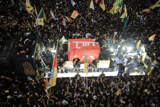 People join a funeral procession for Iran's slain leader Ali Khamenei and members of his family in Karbala early on July 9, 2026. Iranians were preparing on July 9 to bury their slain leader Ali Khamenei in his hometown of Mashhad in northeast Iran, following a multi-day funeral ceremony that attracted millions across various cities in two countries. Following a marathon procession through the holy cities of Najaf and Karbala in neighbouring Iraq, Khamenei would reach his final place of rest in the holy city of Mashhad. (Photo by Murtadha RIDHA / AFP)