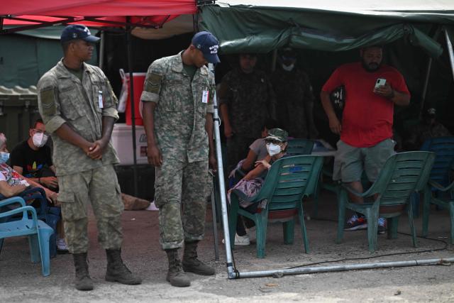 Members of the Brazilian Navy stand outside an emergency hospital set up following the June 24 earthquakes in Caraballeda, La Guaira state, Venezuela on July 8, 2026. Venezuela's government called on July 8, 2026 for the release of frozen assets to help raise funds for the country's recovery from last month's twin earthquakes that killed at least 3,600 people. (Photo by Juan BARRETO / AFP)