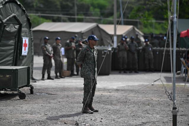 Members of the Brazilian Navy stand outside an emergency hospital set up following the June 24 earthquakes in Caraballeda, La Guaira state, Venezuela on July 8, 2026. Venezuela's government called on July 8, 2026 for the release of frozen assets to help raise funds for the country's recovery from last month's twin earthquakes that killed at least 3,600 people. (Photo by Juan BARRETO / AFP)