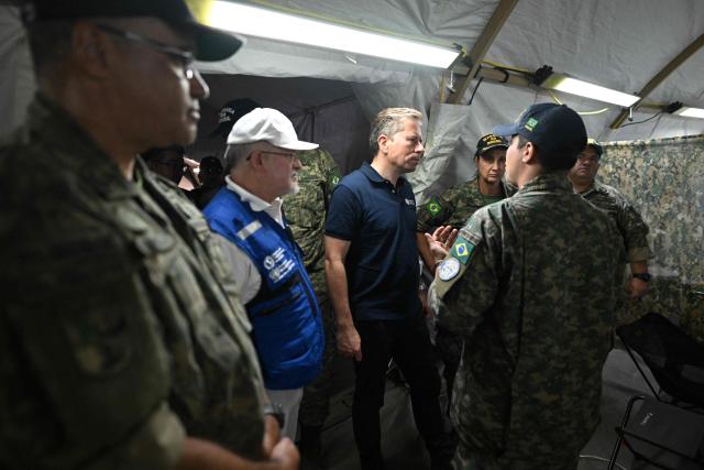 United Nations Under-Secretary-General for Humanitarian Affairs and Emergency Relief Coordinator Tom Fletcher (C) visits an emergency hospital set up by members of the Brazilian Navy following the June 24 earthquakes in Caraballeda, La Guaira state, Venezuela on July 8, 2026. Venezuela's government called on July 8, 2026 for the release of frozen assets to help raise funds for the country's recovery from last month's twin earthquakes that killed at least 3,600 people. (Photo by Juan BARRETO / AFP)