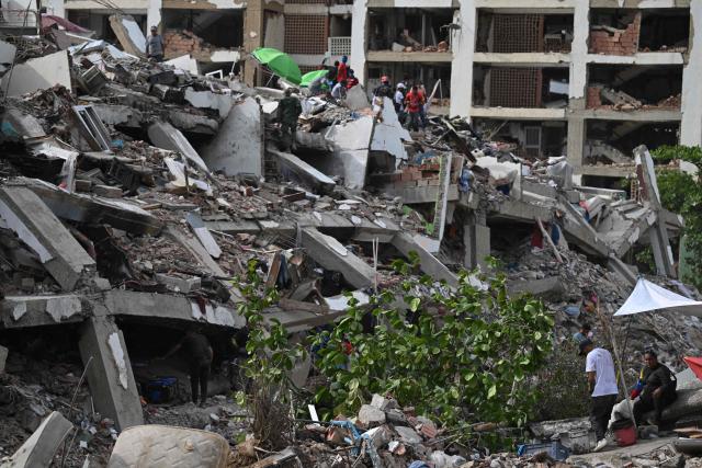 Rescuers search for bodies in a destroyed building in Caraballeda, La Guaira state, Venezuela, on July 8, 2026, following powerful earthquakes that struck the region. Venezuela's government called on July 8, 2026 for the release of frozen assets to help raise funds for the country's recovery from last month's twin earthquakes that killed at least 3,600 people. (Photo by Raul ARBOLEDA / AFP)