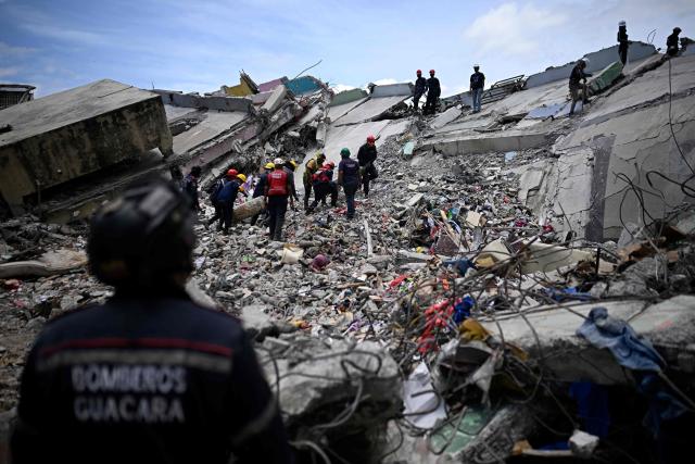 Firefighters and rescue workers operate amid the rubble of collapsed buildings following the June 24 earthquakes in Catia La Mar, La Guaira state, Venezuela on July 8, 2026. Venezuela's government called on July 8, 2026 for the release of frozen assets to help raise funds for the country's recovery from last month's twin earthquakes that killed at least 3,600 people. (Photo by Federico PARRA / AFP)