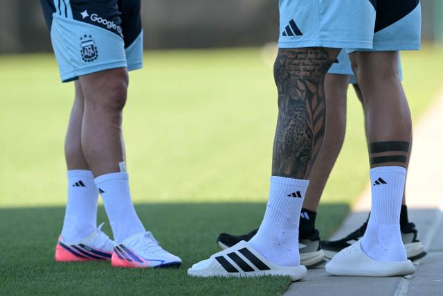 A view of the legs of Argentina's midfielder #24 Enzo Fernandez (R) in flip flops next to forward #09 Julian Alvarez (L) in a training session at the Sporting KC Stadium in Kansas City on July 8, 2026, during the 2026 World Cup tournament. (Photo by JUAN MABROMATA / AFP)