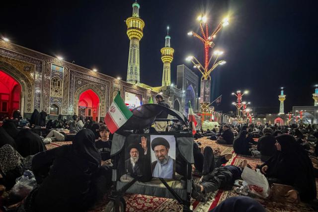 People wait at Imam Reza's shrine for the funeral of slain Iranian leader Ali Khamenei and members of his family in Mashhad early on July 9, 2026. Iranians were preparing on July 9 to bury their slain leader Ali Khamenei in his hometown of Mashhad in northeast Iran, as new US strikes threatened to trigger a fresh escalation in the Middle East war. The late supreme leader's burial follows a multi-day funeral ceremony that attracted millions of mourners across various cities in both Iran and Iraq. (Photo by ATTA KENARE / AFP) / 
