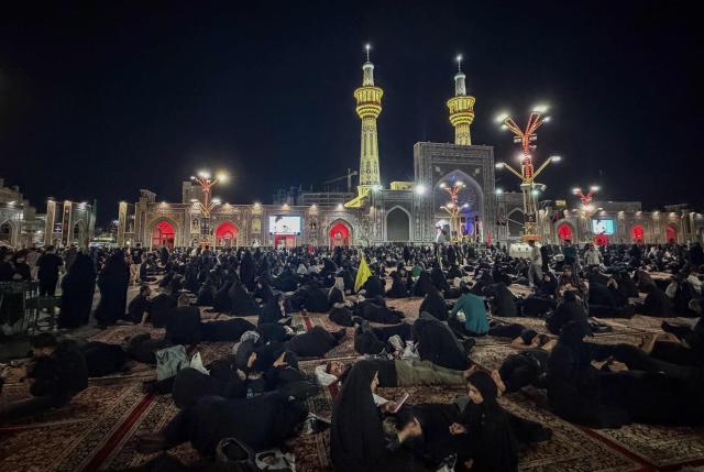 People wait at Imam Reza's shrine for the funeral of slain Iranian leader Ali Khamenei and members of his family in Mashhad early on July 9, 2026. Iranians were preparing on July 9 to bury their slain leader Ali Khamenei in his hometown of Mashhad in northeast Iran, as new US strikes threatened to trigger a fresh escalation in the Middle East war. The late supreme leader's burial follows a multi-day funeral ceremony that attracted millions of mourners across various cities in both Iran and Iraq. (Photo by ATTA KENARE / AFP) / 