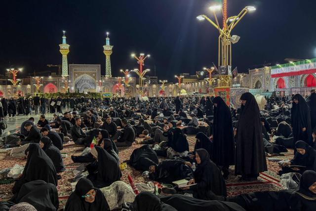 People wait at Imam Reza's shrine for the funeral of slain Iranian leader Ali Khamenei and members of his family in Mashhad early on July 9, 2026. Iranians were preparing on July 9 to bury their slain leader Ali Khamenei in his hometown of Mashhad in northeast Iran, as new US strikes threatened to trigger a fresh escalation in the Middle East war. The late supreme leader's burial follows a multi-day funeral ceremony that attracted millions of mourners across various cities in both Iran and Iraq. (Photo by ATTA KENARE / AFP) / 