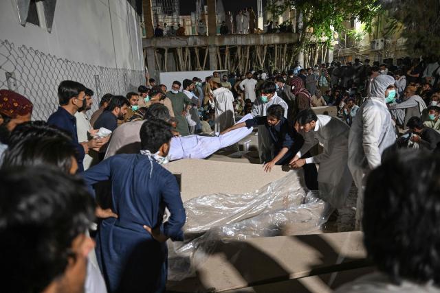 Mourners are seen beside the coffins of police personnel killed in recent militant attacks, outside a hospital in Quetta on July 9, 2026. Three militant attacks in Pakistan's southwestern Balochistan province have killed 42 civilians and security personnel in four days, the country's military said on July 8. (Photo by Banaras KHAN / AFP)
