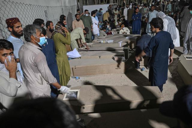 Mourners are seen beside the coffins of police personnel killed in recent militant attacks, outside a hospital in Quetta on July 9, 2026. Three militant attacks in Pakistan's southwestern Balochistan province have killed 42 civilians and security personnel in four days, the country's military said on July 8. (Photo by Banaras KHAN / AFP)