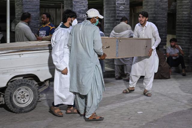Mourners carry the coffin of a police victim killed in recent militant attacks, at a hospital in Quetta on July 9, 2026. Three militant attacks in Pakistan's southwestern Balochistan province have killed 42 civilians and security personnel in four days, the country's military said on July 8. (Photo by Banaras KHAN / AFP)