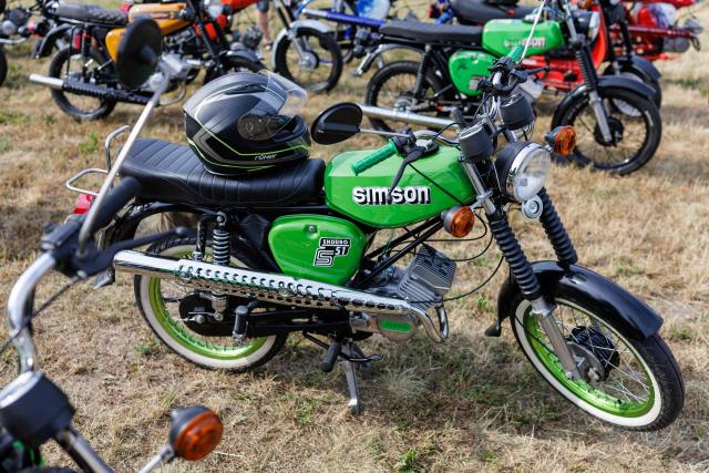 A Simson moped is pictured during an election campaign event of the far-right Alternative for Germany (AfD) party's and a motorbike and moped ride in Jessnitz, eastern Germany on June 28, 2026. Fans of far-right Alternative for Germany party's top candidate for the regional elections in Saxony-Anhalt, Ulrich Siegmund joined him for a countryside ride on Simson-brand scooters, that have become a symbol of East German identity. Descendants of the Simson firm's namesake Jewish founders, who gave up the company to escape persecution in Nazi Germany, have denounced the AfD's appropriation of the brand name. (Photo by Jens SCHLÜTER / AFP)