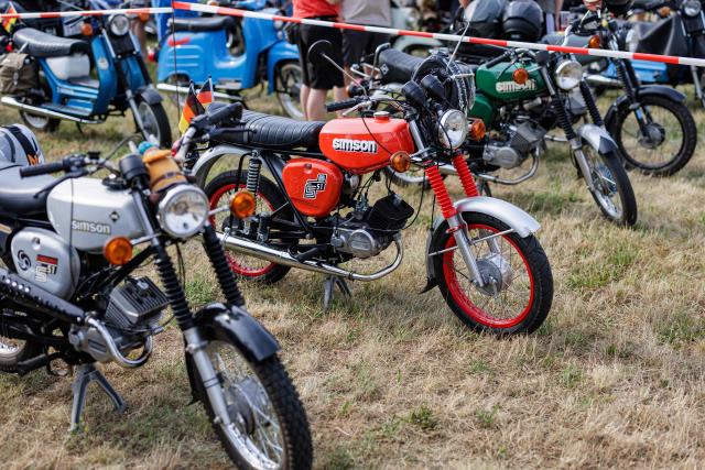 A Simson moped is pictured during an election campaign event of the far-right Alternative for Germany (AfD) party's and a motorbike and moped ride in Jessnitz, eastern Germany on June 28, 2026. Fans of far-right Alternative for Germany party's top candidate for the regional elections in Saxony-Anhalt, Ulrich Siegmund joined him for a countryside ride on Simson-brand scooters, that have become a symbol of East German identity. Descendants of the Simson firm's namesake Jewish founders, who gave up the company to escape persecution in Nazi Germany, have denounced the AfD's appropriation of the brand name. (Photo by Jens SCHLÜTER / AFP)