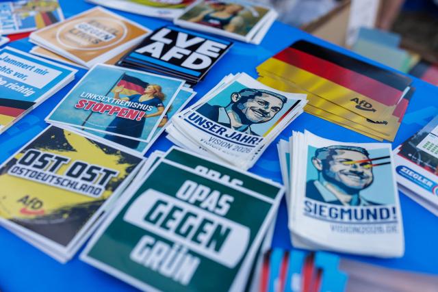 Campaign material depicting Ulrich Siegmund, the far-right Alternative for Germany party's top candidate for the regional elections in Saxony-Anhalt is pictured during an election campaign event of the far-right Alternative for Germany (AfD) party's and a motorbike and moped ride in Jessnitz, eastern Germany on June 28, 2026. Fans of far-right Alternative for Germany party's top candidate for the regional elections in Saxony-Anhalt, Ulrich Siegmund joined him for a countryside ride on Simson-brand scooters, that have become a symbol of East German identity. Descendants of the Simson firm's namesake Jewish founders, who gave up the company to escape persecution in Nazi Germany, have denounced the AfD's appropriation of the brand name. (Photo by Jens SCHLÜTER / AFP)