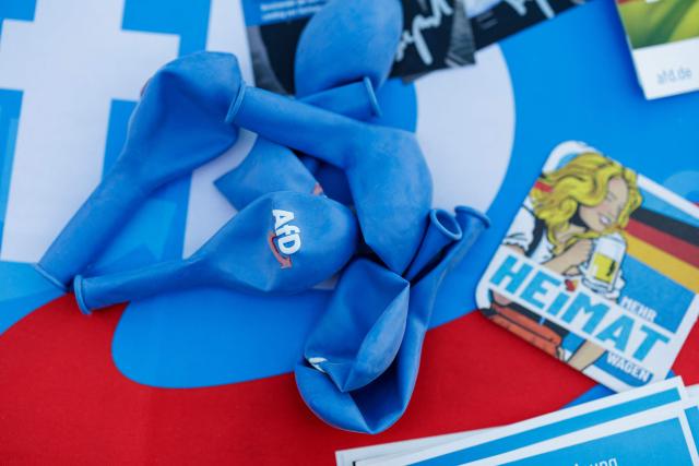 Balloons as campaign material lies on a table during a campaign event of the far-right Alternative for Germany (AfD) party's and a motorbike and moped ride in Jessnitz, eastern Germany on June 28, 2026. Fans of far-right Alternative for Germany party's top candidate for the regional elections in Saxony-Anhalt, Ulrich Siegmund joined him for a countryside ride on Simson-brand scooters, that have become a symbol of East German identity. Descendants of the Simson firm's namesake Jewish founders, who gave up the company to escape persecution in Nazi Germany, have denounced the AfD's appropriation of the brand name. (Photo by Jens SCHLÜTER / AFP)