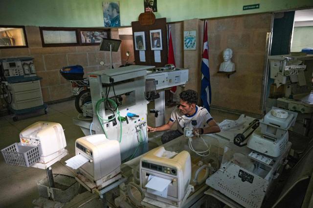 A specialist in electromedical equipment works at the provincial electromedical workshop in Havana on July 1, 2026. In the midst of one of the worst economic crises Cuba has experienced in decades, the health system is striving to maintain its services and priority programmes despite medicine and supply shortages, technological deterioration, staff shortages, prolonged power cuts and the impact of the United States sanctions. (Photo by YAMIL LAGE / AFP)