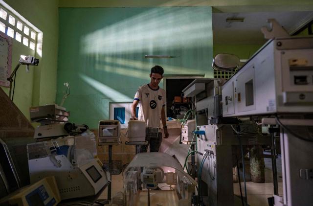 A specialist in electromedical equipment works at the provincial electromedical workshop in Havana on July 1, 2026. In the midst of one of the worst economic crises Cuba has experienced in decades, the health system is striving to maintain its services and priority programmes despite medicine and supply shortages, technological deterioration, staff shortages, prolonged power cuts and the impact of the United States sanctions. (Photo by YAMIL LAGE / AFP)