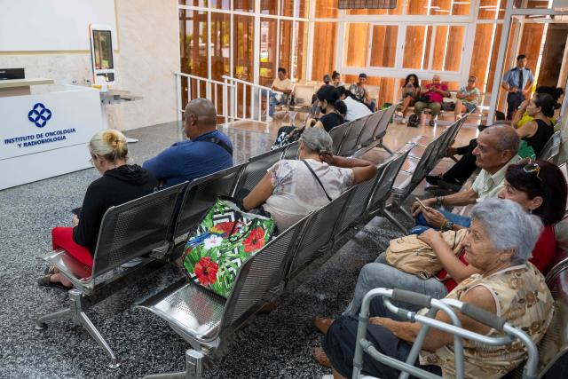 Patients wait at the Institute of Oncology and Radiobiology in Havana on July 1, 2026. In the midst of one of the worst economic crises Cuba has experienced in decades, the health system is striving to maintain its services and priority programmes despite medicine and supply shortages, technological deterioration, staff shortages, prolonged power cuts and the impact of the United States sanctions. (Photo by YAMIL LAGE / AFP)