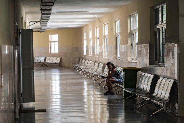 A woman remains sitting at the Oncology and Radiobiology Institute in Havana on 1 July 2026. In the midst of one of the worst economic crises Cuba has experienced in decades, the health system is striving to maintain its services and priority programmes despite medicine and supply shortages, technological deterioration, staff shortages, prolonged power cuts and the impact of the United States sanctions. (Photo by YAMIL LAGE / AFP)