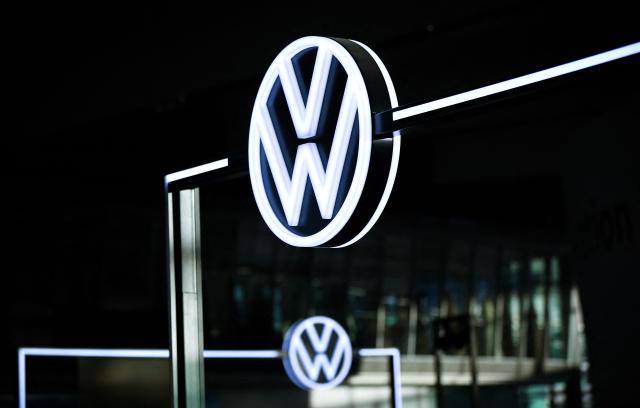 (FILES) The illuminated VW Logo is pictured in the customer centre at the headquarters of German carmaker Volkswagen (VW) in Wolfsburg, central Germany, on November 21, 2025. German auto giant Volkswagen's management meet on July 9, 2026 to thrash out plans for what could be the biggest ever restructuring in the global auto industry with unions set to protest any mass job cuts. (Photo by Ronny HARTMANN / AFP)