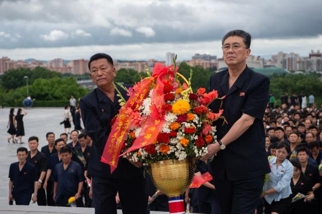 People visit the statues of late North Korean leaders Kim Il Sung and Kim Jong Il on the 32nd anniversary of Kim Il Sung's death, at Mansu Hill in Pyongyang on July 8, 2026. (Photo by KIM Won Jin / AFP)