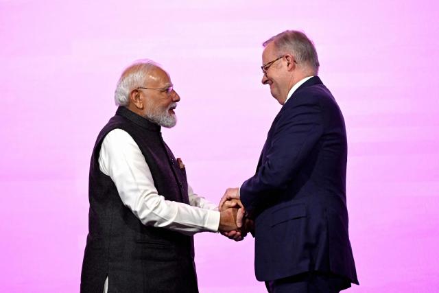 Indian Prime Minister Narendra Modi (L) and Australia’s Prime Minister Anthony Albanese shake hands at the Australia-India Economic Roadmap Business Reception in Melbourne on July 9, 2026. (Photo by WILLIAM WEST / AFP)