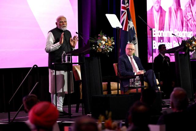 Indian Prime Minister Narendra Modi (L) speaks as Australia’s Prime Minister Anthony Albanese (R) listens at the Australia-India Economic Roadmap Business Reception in Melbourne on July 9, 2026. (Photo by WILLIAM WEST / AFP)