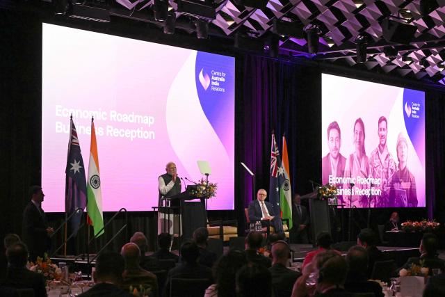 Indian Prime Minister Narendra Modi (L) speaks as Australia’s Prime Minister Anthony Albanese (R) listens at the Australia-India Economic Roadmap Business Reception in Melbourne on July 9, 2026. (Photo by WILLIAM WEST / AFP)