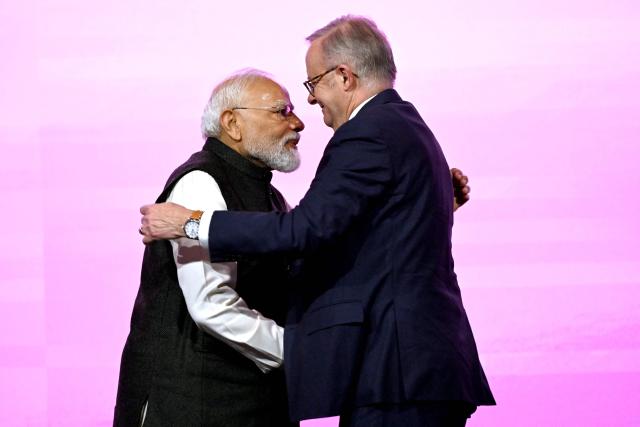 Indian Prime Minister Narendra Modi (L) embraces Australia’s Prime Minister Anthony Albanese at the Australia-India Economic Roadmap Business Reception in Melbourne on July 9, 2026. (Photo by WILLIAM WEST / AFP)