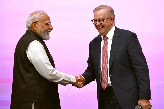 Indian Prime Minister Narendra Modi (L) shakes hands with Australia’s Prime Minister Anthony Albanese at the Australia-India Economic Roadmap Business Reception in Melbourne on July 9, 2026. (Photo by WILLIAM WEST / AFP)