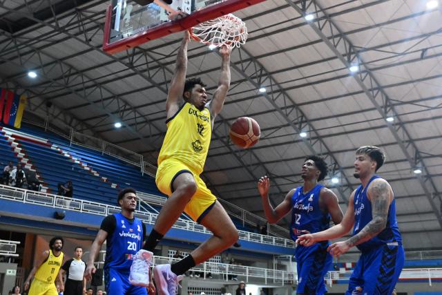 Colombia's Jaime Echenique dunks the ball during the FIBA Basketball World Cup 2027 Americas qualifiers Group C match between Venezuela and Colombia, at the Evangelista Mora Colisseum in Cali, Valle del Cauca, Colombia, on July 8, 2026. (Photo by Joaquin SARMIENTO / AFP)