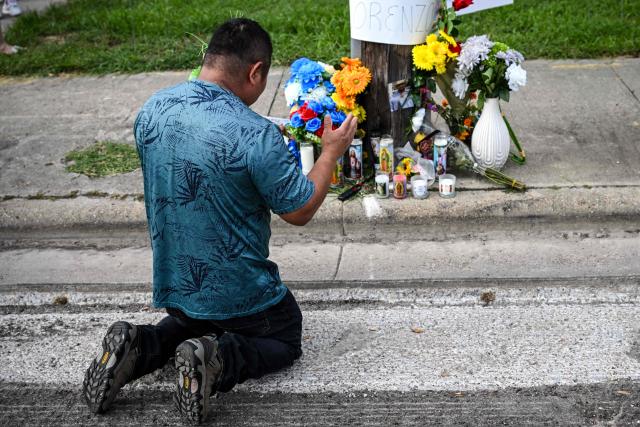 A man kneels in front of a memorial where Lorenzo Salgado was killed by an ICE agent during a protest in Houston, Texas, on July 8, 2026. US Department of Homeland Security (DHS) officials said Tuesday that a federal immigration agent shot and killed a Mexican national during an attempted vehicle stop in Texas. In a statement posted to X, DHS said Immigration and Customs Enforcement (ICE) agents attempted to stop Lorenzo Salgado's vehicle in Houston early Tuesday morning, but the man "attempted to evade arrest." (Photo by RONALDO SCHEMIDT / AFP)