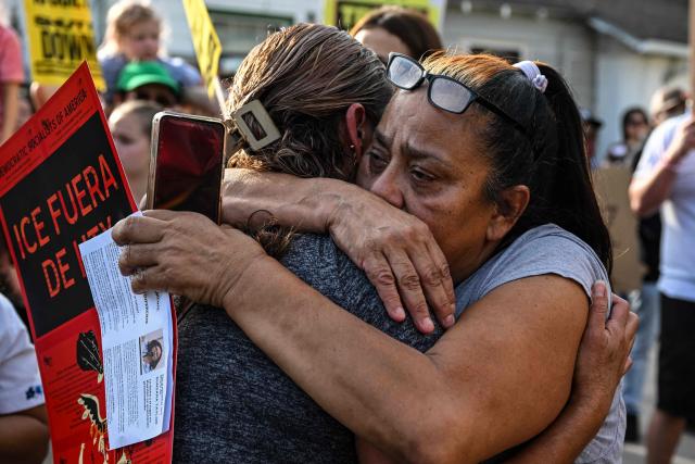 Two women embrace next to a memorial where Lorenzo Salgado was killed by an ICE agent during a protest in Houston, Texas, on July 8, 2026. US Department of Homeland Security (DHS) officials said Tuesday that a federal immigration agent shot and killed a Mexican national during an attempted vehicle stop in Texas. In a statement posted to X, DHS said Immigration and Customs Enforcement (ICE) agents attempted to stop Lorenzo Salgado's vehicle in Houston early Tuesday morning, but the man "attempted to evade arrest." (Photo by RONALDO SCHEMIDT / AFP)