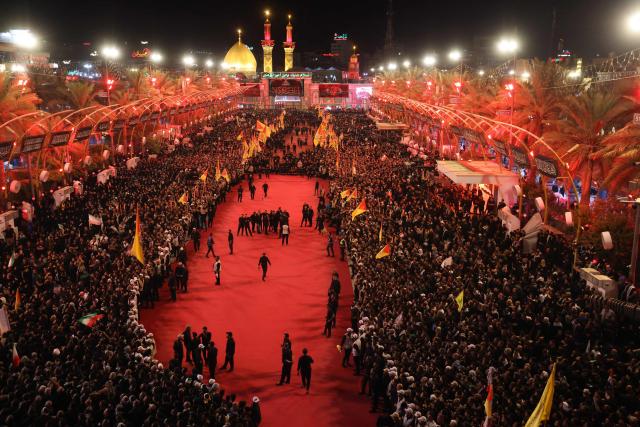 Mourners take part in the funeral procession of Iran's late supreme leader Ayatollah Ali Khamenei at Imam Hussein Shrine in Karbala early on July 9, 2026. Iranians were preparing on July 9 to bury their slain leader Ali Khamenei in his hometown of Mashhad in northeast Iran, as new US strikes threatened to trigger a fresh escalation in the Middle East war. The late leader's burial follows a multi-day funeral ceremony that attracted millions of mourners across various cities in both Iran and Iraq. (Photo by Ahmad AL-RUBAYE / AFP)