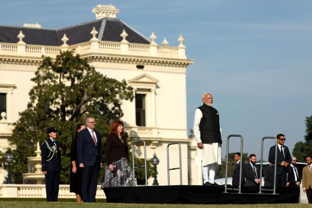 Australia’s Prime Minister Anthony Albanese (2nd L) stands next to Indian Prime Minister Narendra Modi (C) as he participates in an official welcoming ceremony at Government House Victoria in Melbourne on July 9, 2026. (Photo by MARTIN KEEP / AFP)
