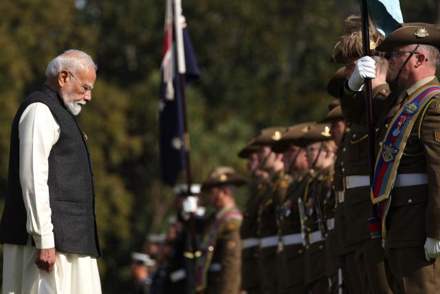 Indian Prime Minister Narendra Modi (L) reviews a guard of honour as he takes part in an official welcoming ceremony at Government House Victoria in Melbourne on July 9, 2026. (Photo by MARTIN KEEP / AFP)