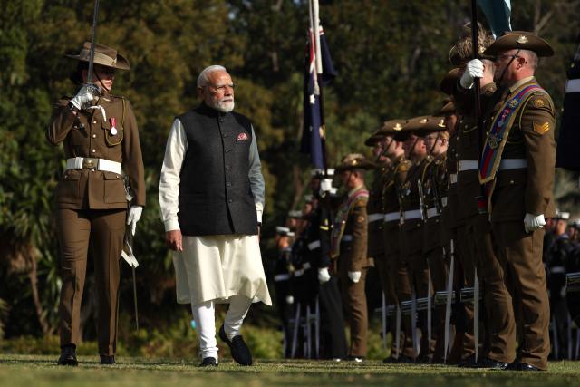 Indian Prime Minister Narendra Modi (2nd L) reviews a guard of honour as he takes part in an official welcoming ceremony at Government House Victoria in Melbourne on July 9, 2026. (Photo by MARTIN KEEP / AFP)
