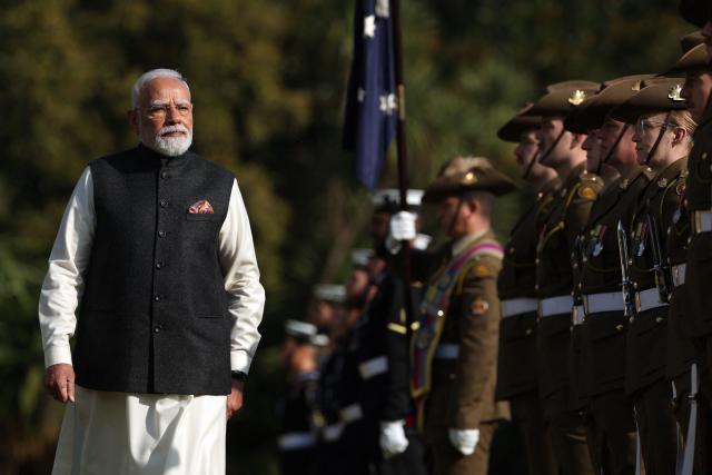 Indian Prime Minister Narendra Modi (L) reviews a guard of honour as he takes part in an official welcoming ceremony at Government House Victoria in Melbourne on July 9, 2026. (Photo by MARTIN KEEP / AFP)