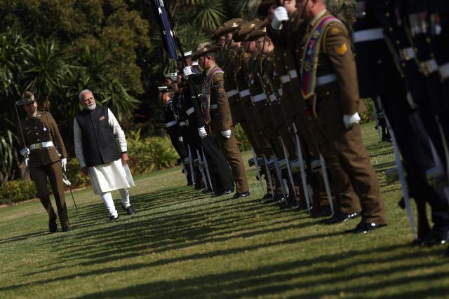 Indian Prime Minister Narendra Modi (2nd L) reviews a guard of honour as he takes part in an official welcoming ceremony at Government House Victoria in Melbourne on July 9, 2026. (Photo by MARTIN KEEP / AFP)