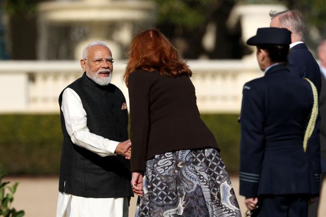 Indian Prime Minister Narendra Modi (L) shakes hands with the Governor of Victoria Margaret Gardner (C) as he arrives for an official welcoming ceremony at Government House Victoria in Melbourne on July 9, 2026. (Photo by MARTIN KEEP / AFP)