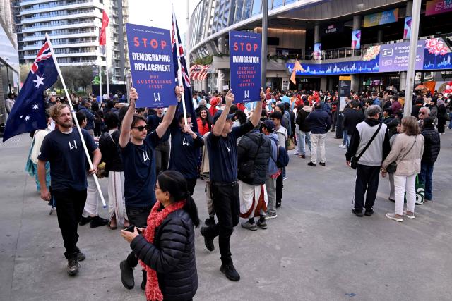Anti-immigration protesters hold placards and signs outside the venue for a community event with Indian Prime Minister Narendra Modi at Docklands Stadium in Melbourne on July 9, 2026. (Photo by WILLIAM WEST / AFP)