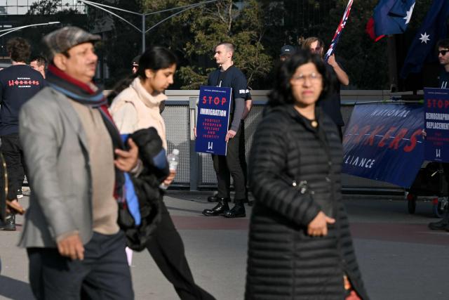 Anti-immigration protesters hold placards and signs outside the venue for a community event with Indian Prime Minister Narendra Modi at Docklands Stadium in Melbourne on July 9, 2026. (Photo by WILLIAM WEST / AFP)