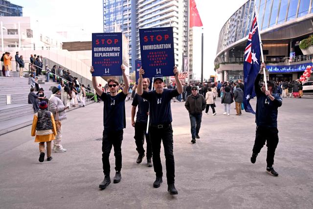 Anti-immigration protesters hold placards and signs outside the venue for a community event with Indian Prime Minister Narendra Modi at Docklands Stadium in Melbourne on July 9, 2026. (Photo by WILLIAM WEST / AFP)