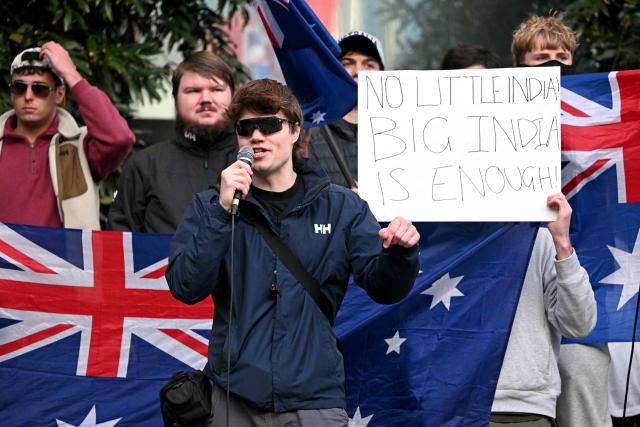 Anti-immigration protesters hold placards and flags outside the venue for a community event with Indian Prime Minister Narendra Modi at Docklands Stadium in Melbourne on July 9, 2026. (Photo by WILLIAM WEST / AFP)