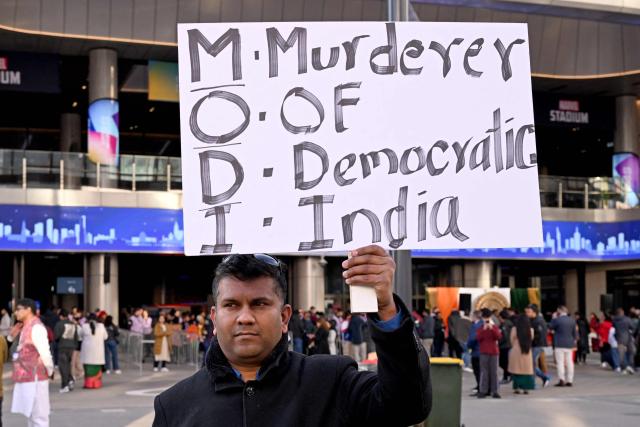 A non-supporter of Indian Prime Minister Narendra Modi holds a placard outside the venue for a community event, at which Modi will speak, at Docklands Stadium in Melbourne on July 9, 2026. (Photo by WILLIAM WEST / AFP)